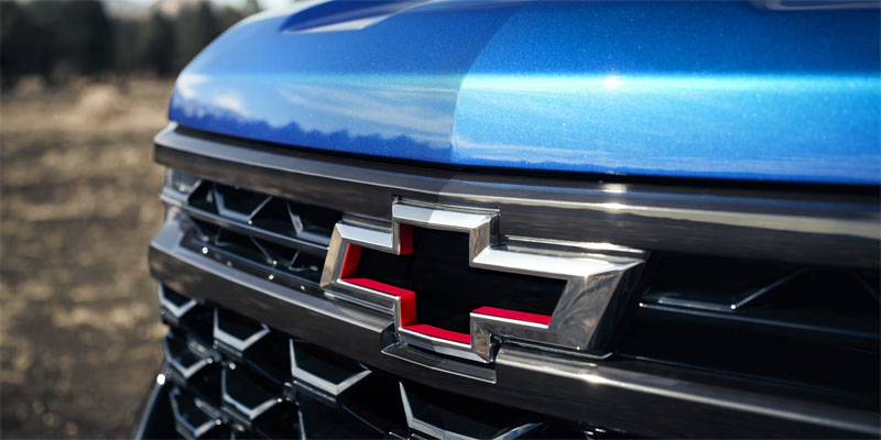 Close-up of Chevrolet logo on blue vehicle grille
